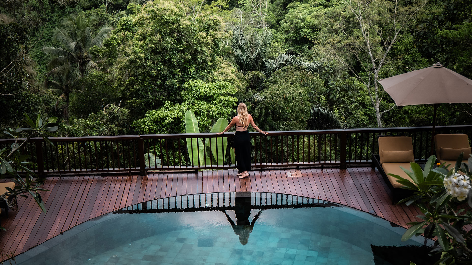 Guest overlooking the tropical jungle from a private pool at Nandini Jungle