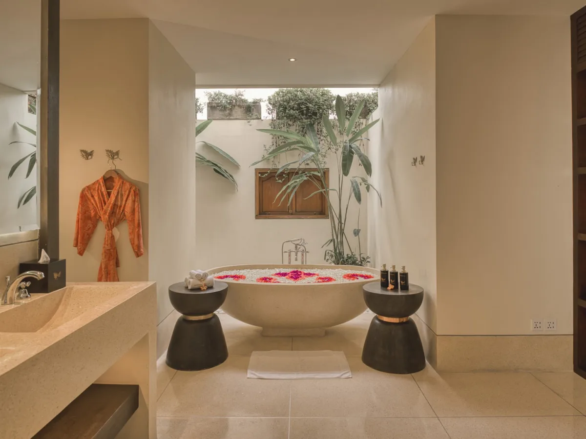 Panoramic Corner Jacuzzi Royal Suite bathroom with romantic flower bath and elegant vanity in Ubud, Bali
