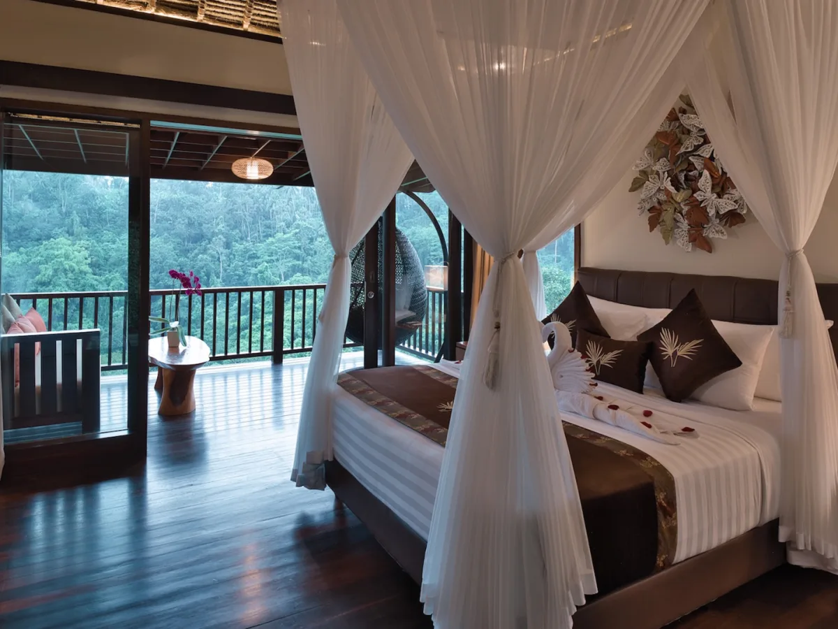 Canopy bed inside the Panoramic Jungle View Villa with private balcony and rainforest views in Ubud, Bali