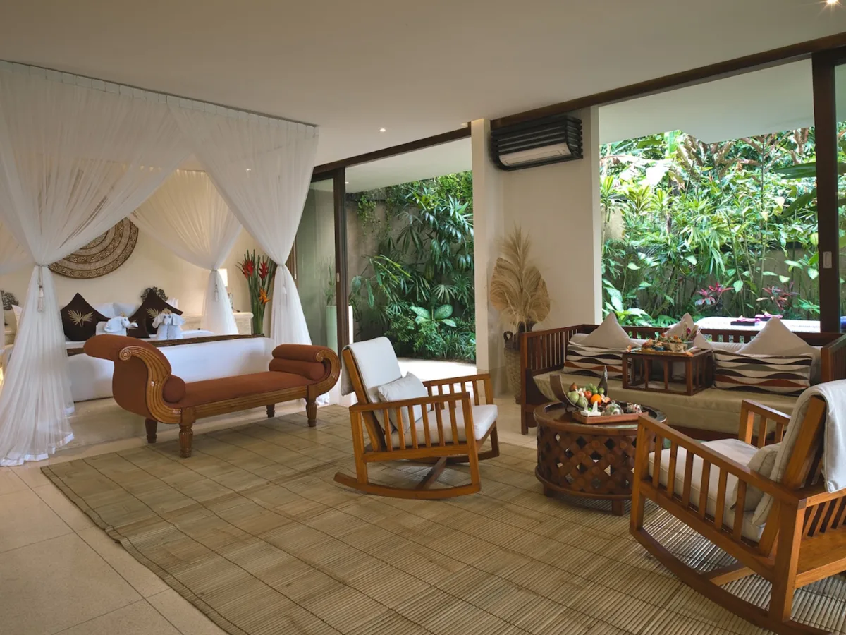 Spacious Presidential Royal Suite with canopy bedroom, living area, and private garden views in Ubud, Bali