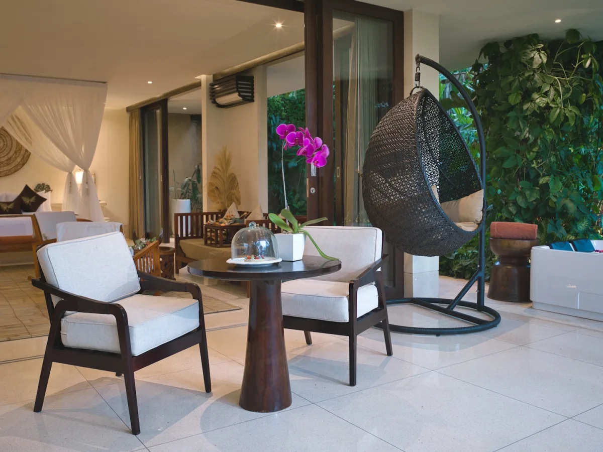 Private terrace of the Presidential Royal Suite with canopy bedroom, hanging chair, and jacuzzi in Ubud, Bali