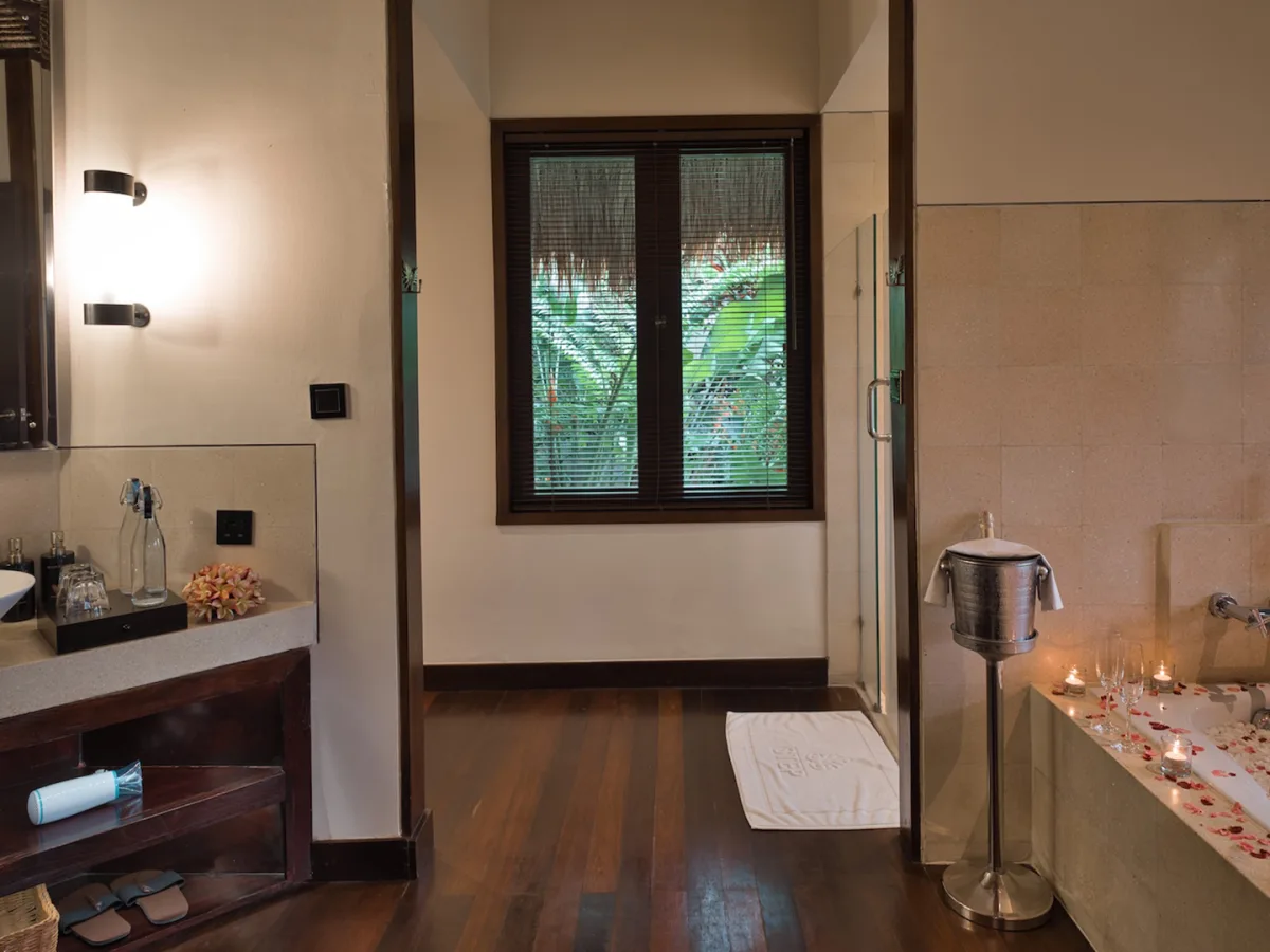 Sunrise View Villa bathroom with romantic flower bath setup, vanity, and tropical garden view in Ubud, Bali