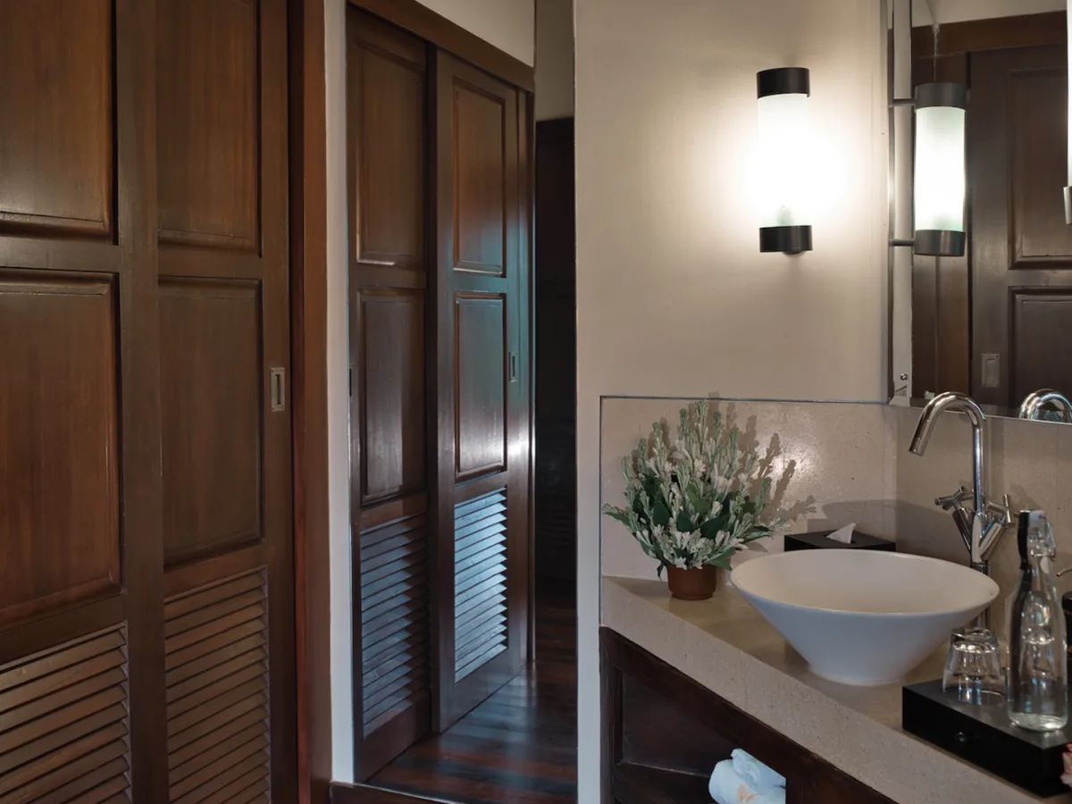 Sunrise View Villa bathroom with vanity, mirror, and wooden wardrobe in Ubud, Bali