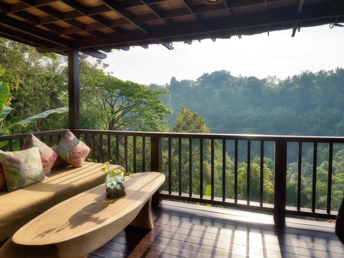 Private balcony of the Sunrise View Villa with golden morning light and rainforest views in Ubud, Bali
