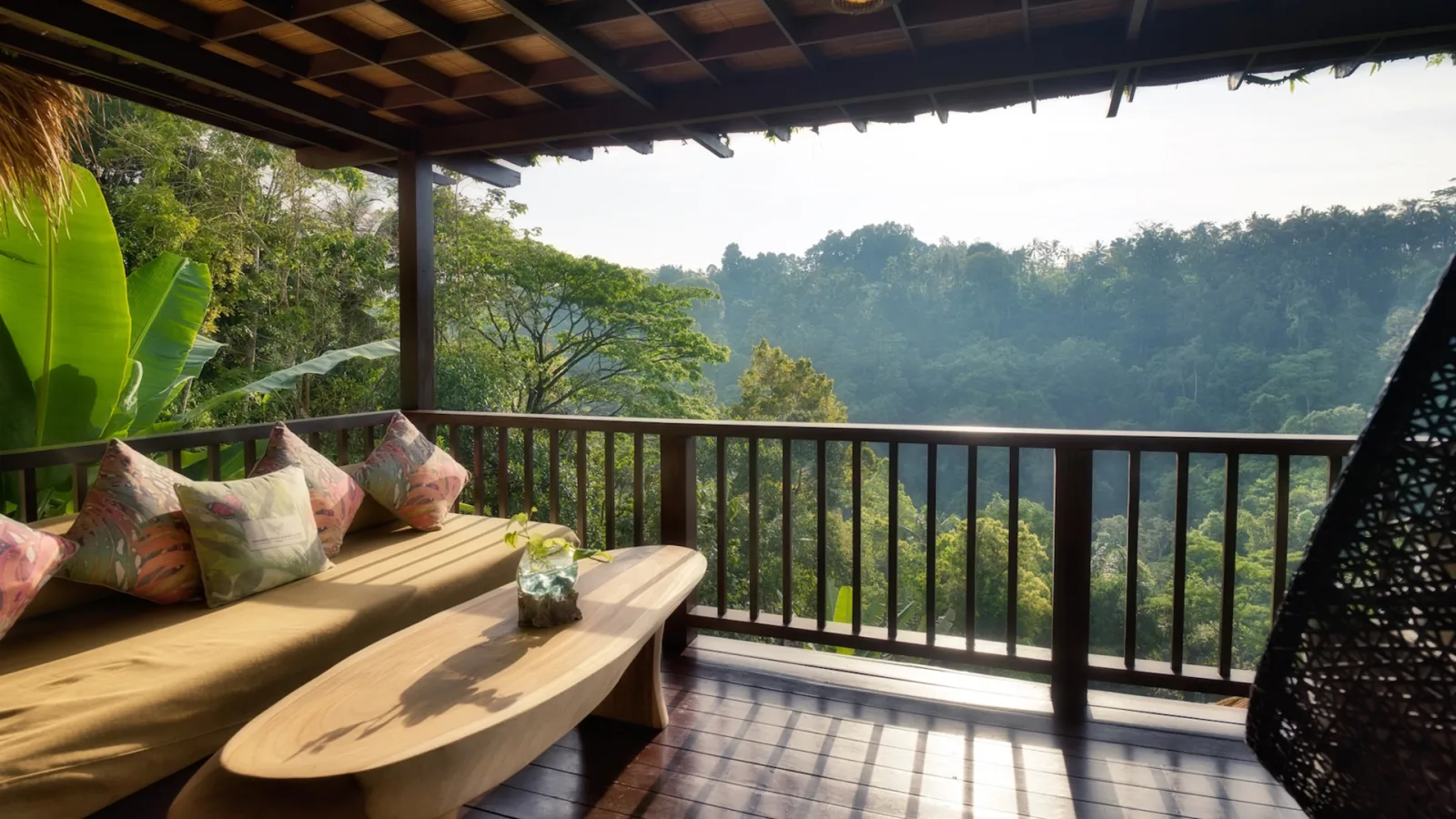 Private balcony of the Sunrise View Villa with golden morning light and rainforest views in Ubud, Bali