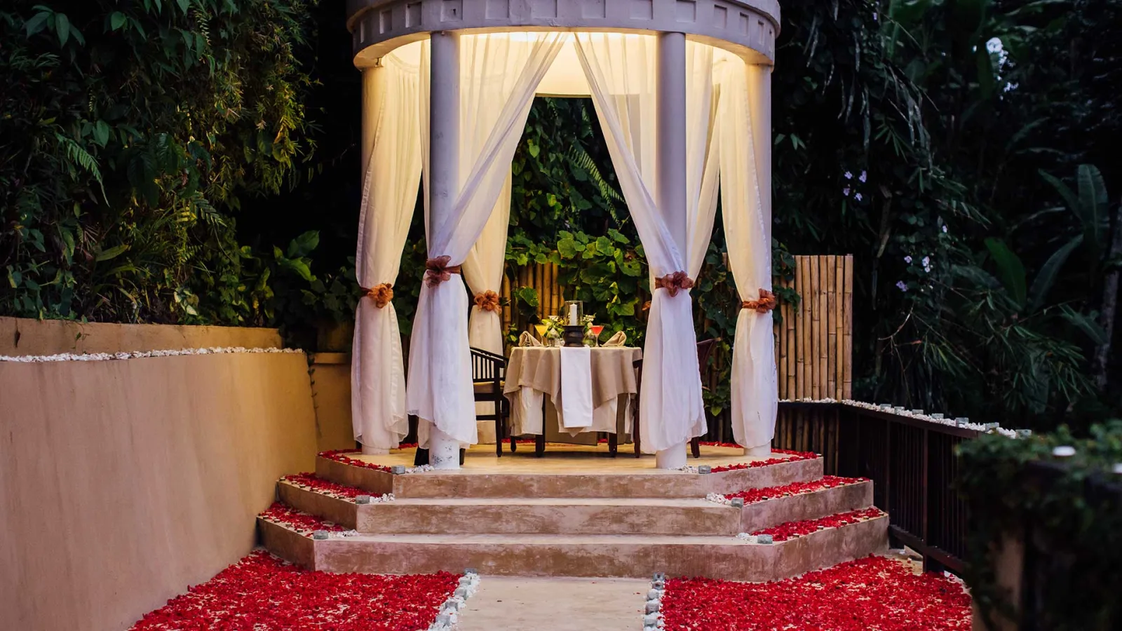 Romantic candlelit dining setup at The Chapel surrounded by jungle at Nandini Jungle by Hanging Gardens