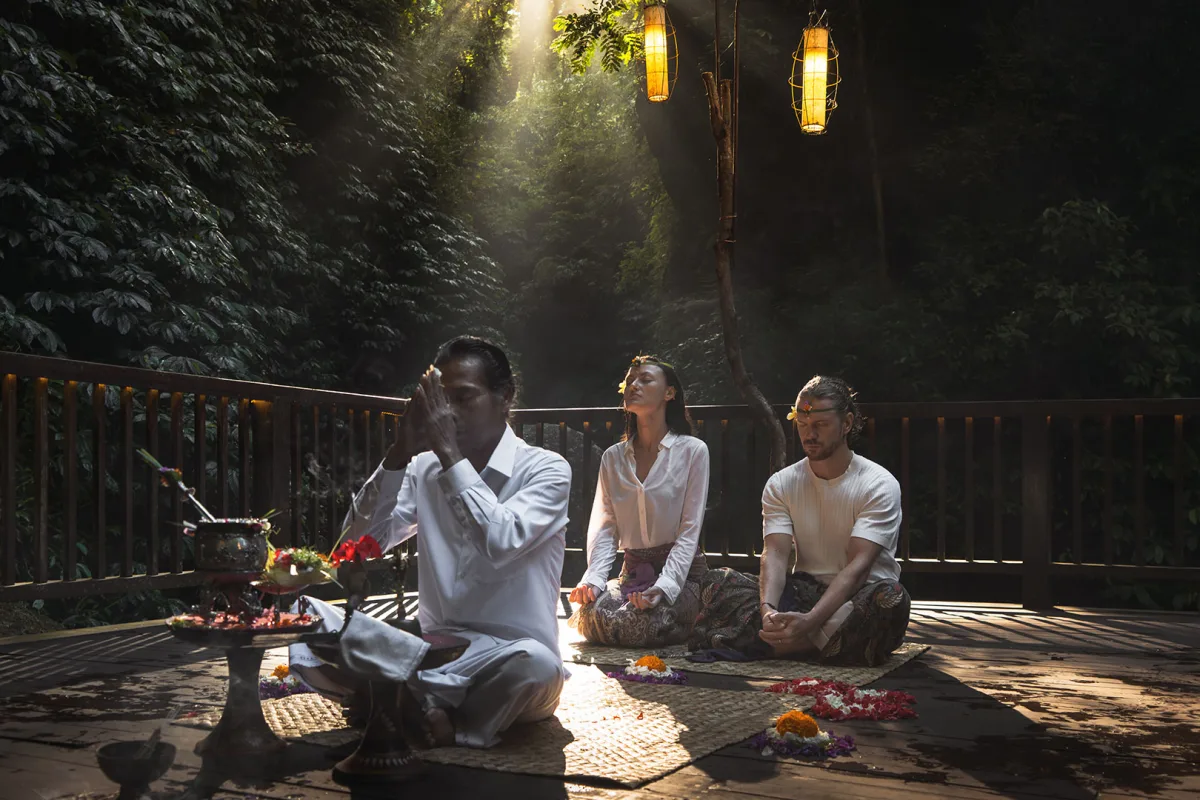 Couple joining a traditional Balinese purification ritual during the Self-Healing Day Pass at Nandini Jungle by Hanging Gardens.