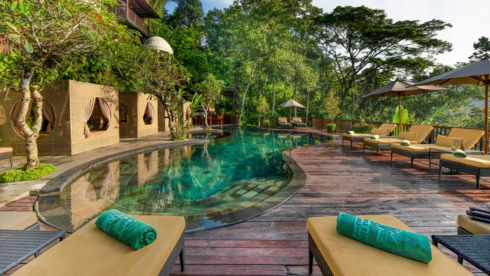Jungle swimming pool with sun loungers at Nandini Jungle by Hanging Gardens in Ubud, Bali.