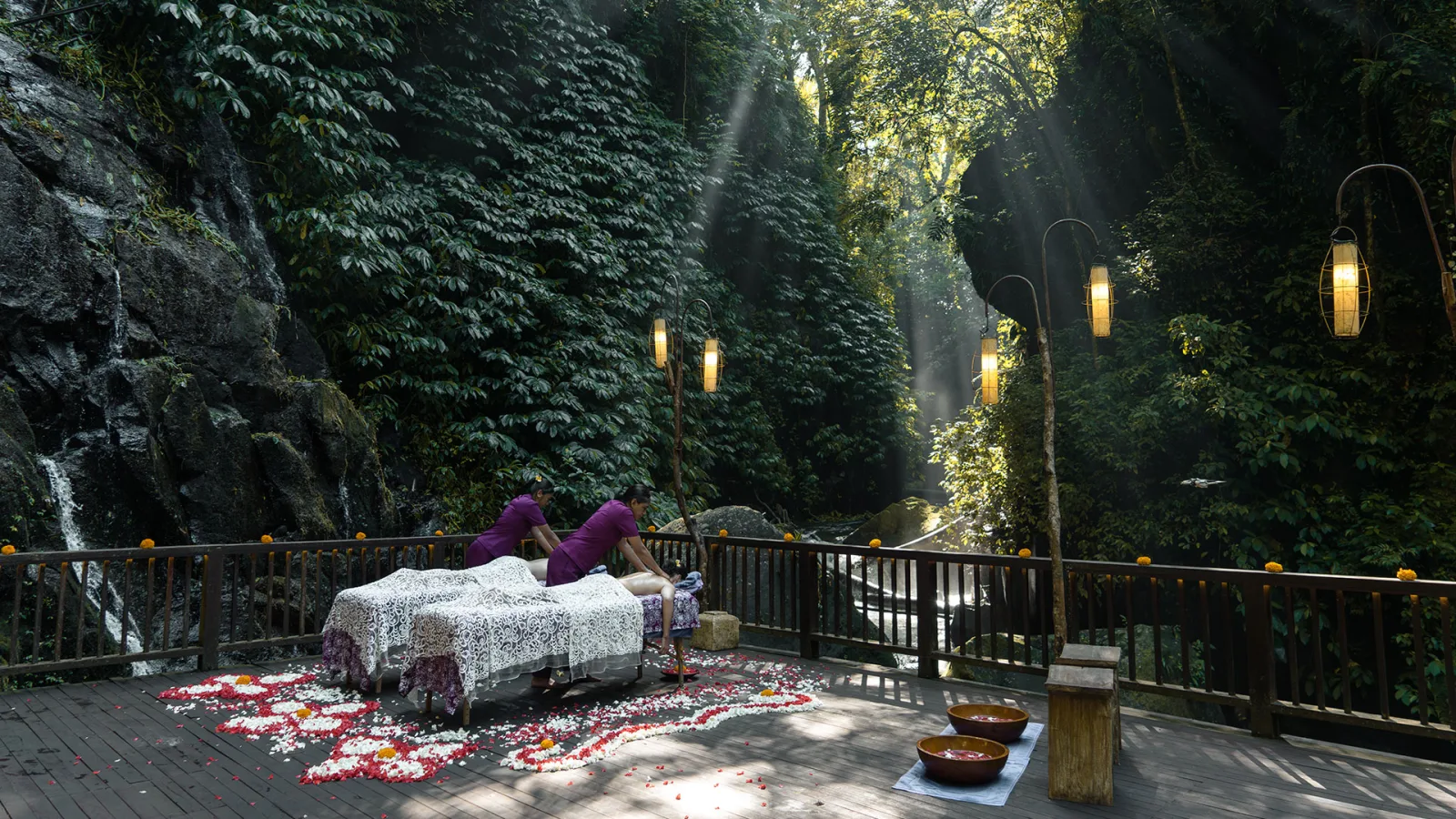 Outdoor spa treatment surrounded by tropical jungle and waterfall at Nandini Jungle Bali